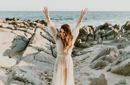 bride in shimmering gold dress at beach