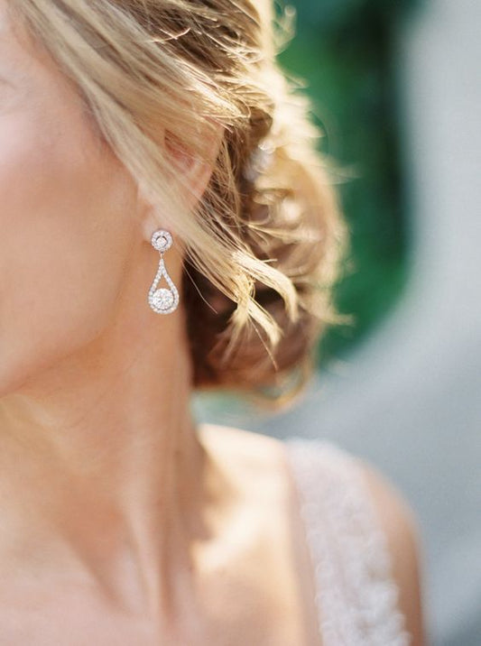 blonde bride wearing drop style circle diamond earrings